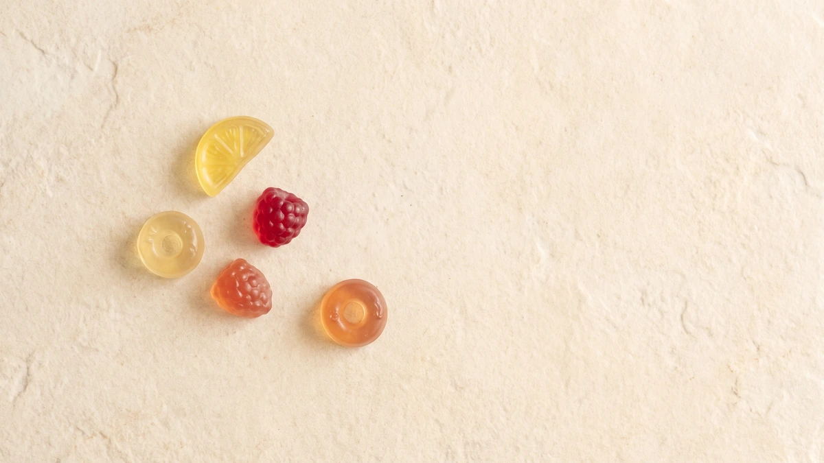 Translucent THC gummies on a clean stone surface